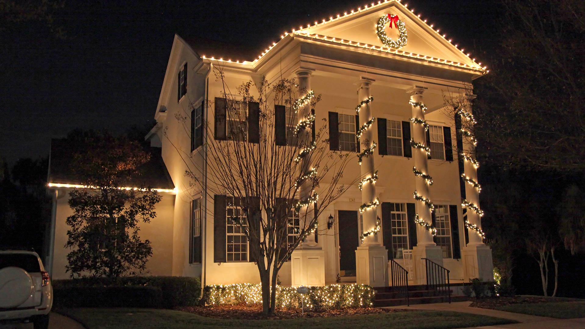 A beautiful home with Christmas lights adorning its exterior in Arlington, VA.