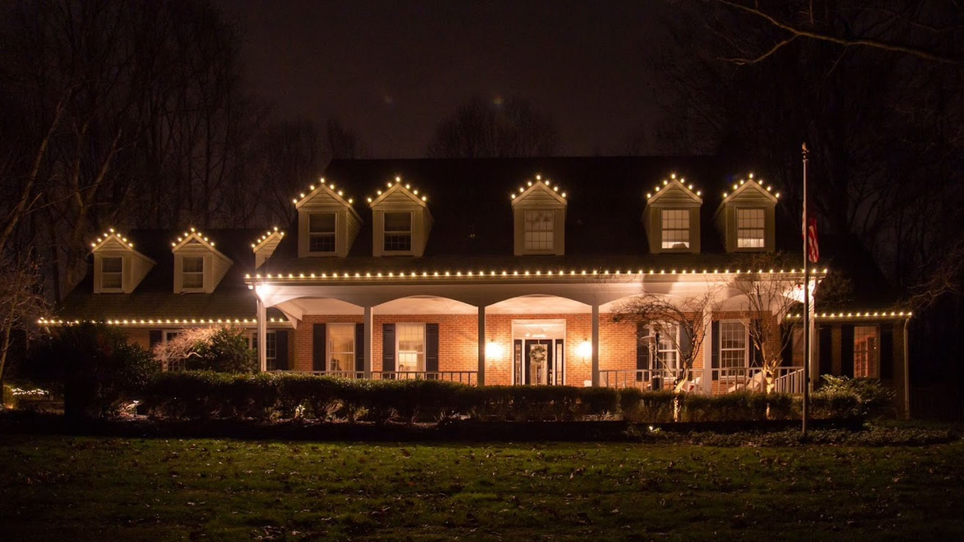 A beautiful home with Christmas lights adorning its exterior in Arlington, VA.