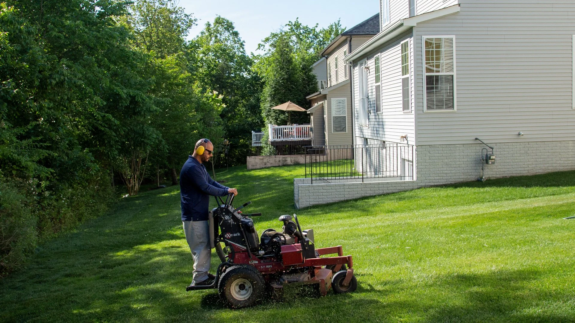 Our lawn maintenance professional mowing a lawn for a client in Haymarket, VA.