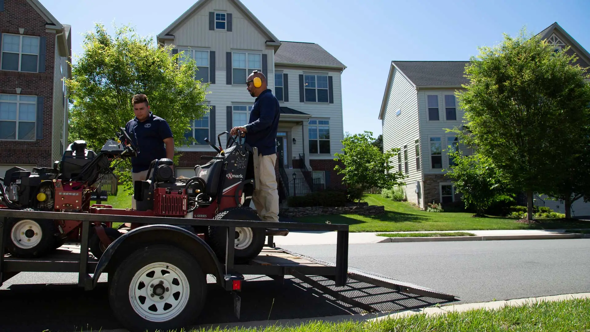 Hambleton Lawn & Landscape professionals unloading truck in neighborhood in Sterling, VA.