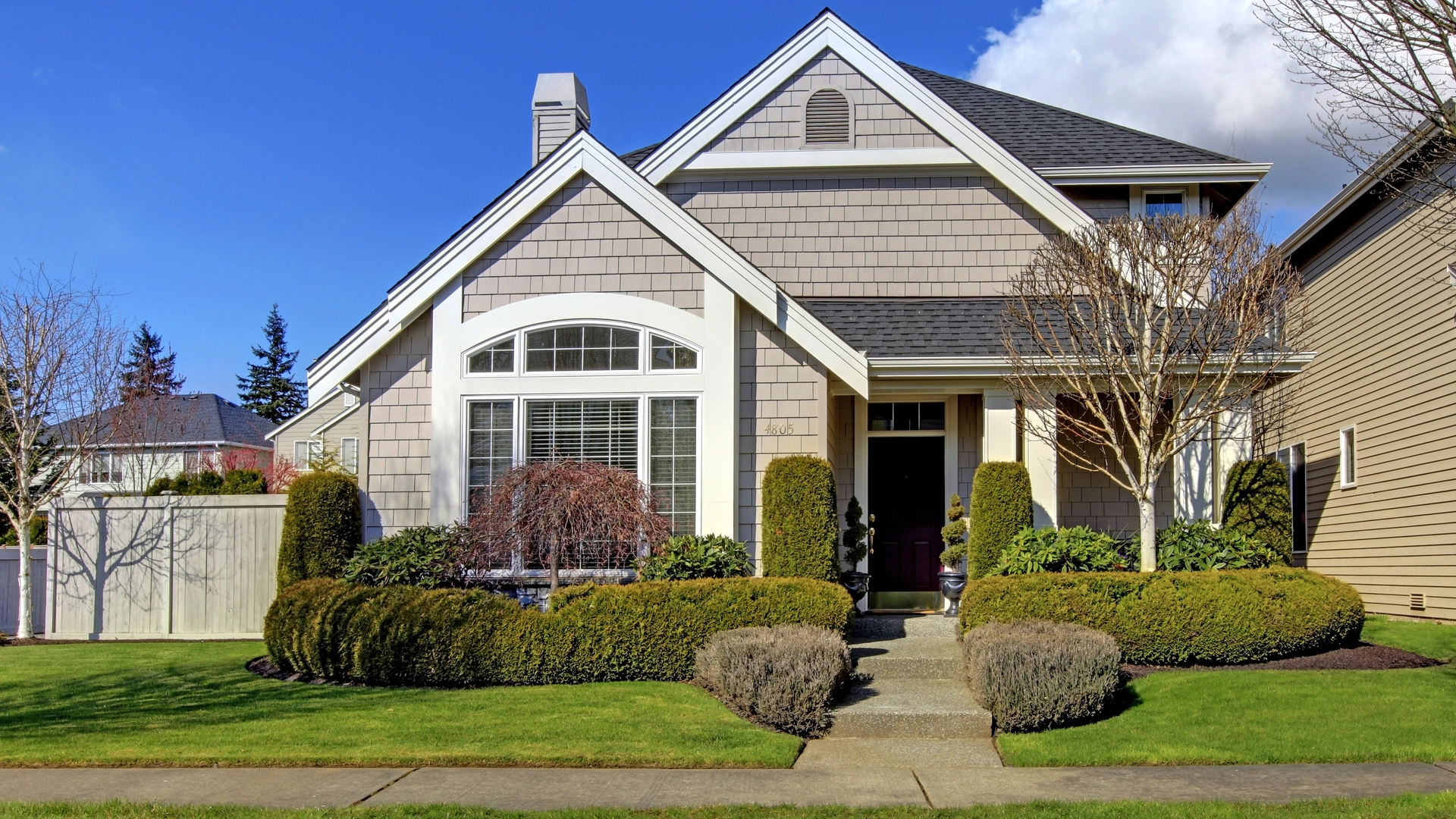 A home in Front Royal, VA with neatly trimmed trees and shrubs.