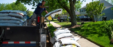 Professional unloading bags of mulch from a truck in Falls Church, VA.